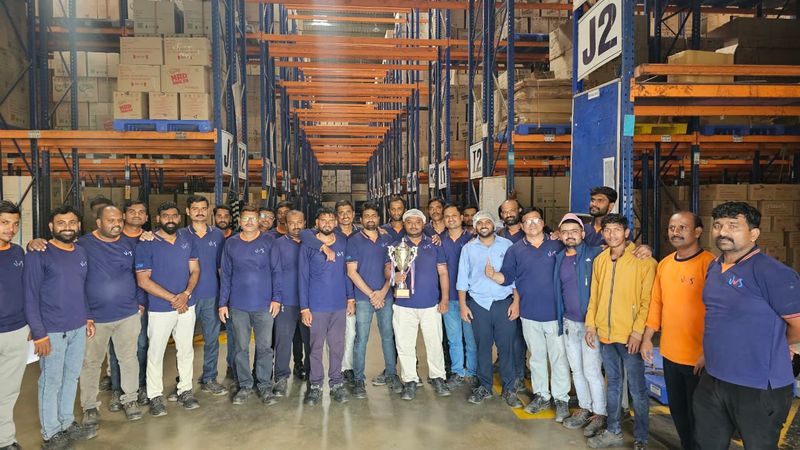 JSM Logistics staff group photograph in the warehouse